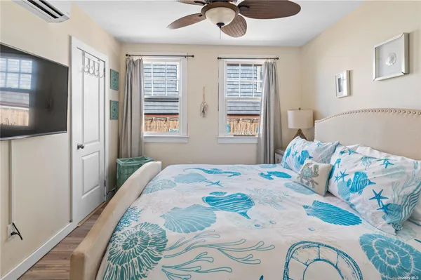 a bedroom with a bed dresser and a window