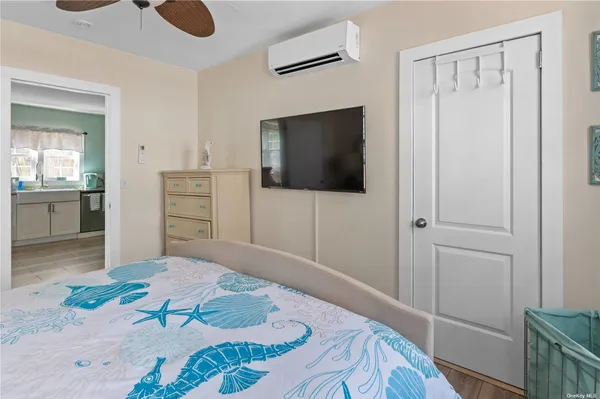 a bedroom with a bed and a flat screen tv