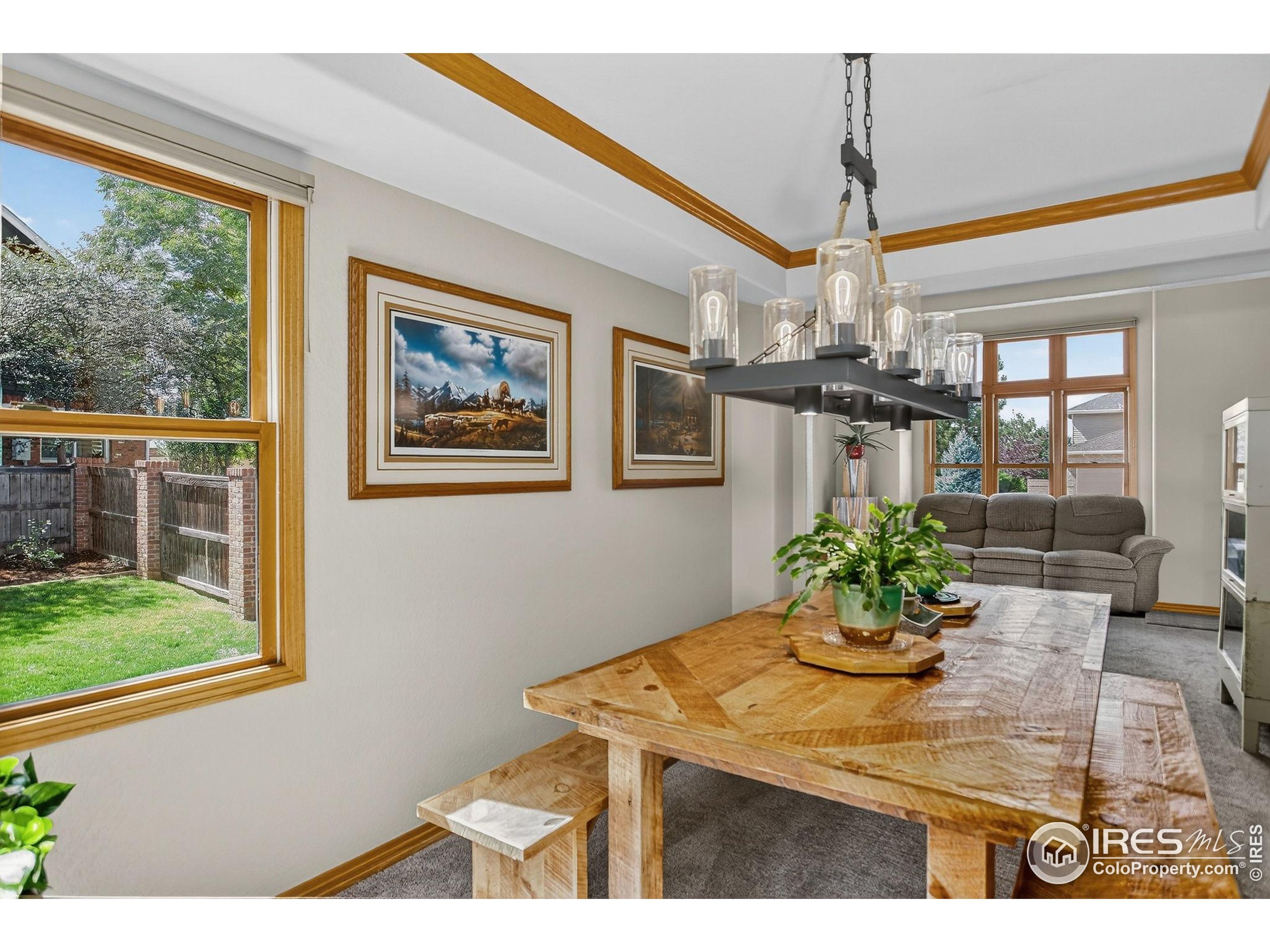 1840 Red Cloud Road Longmont, CO 80504 - Photo 11 of 42 a view of a dining room with furniture window and wooden floor