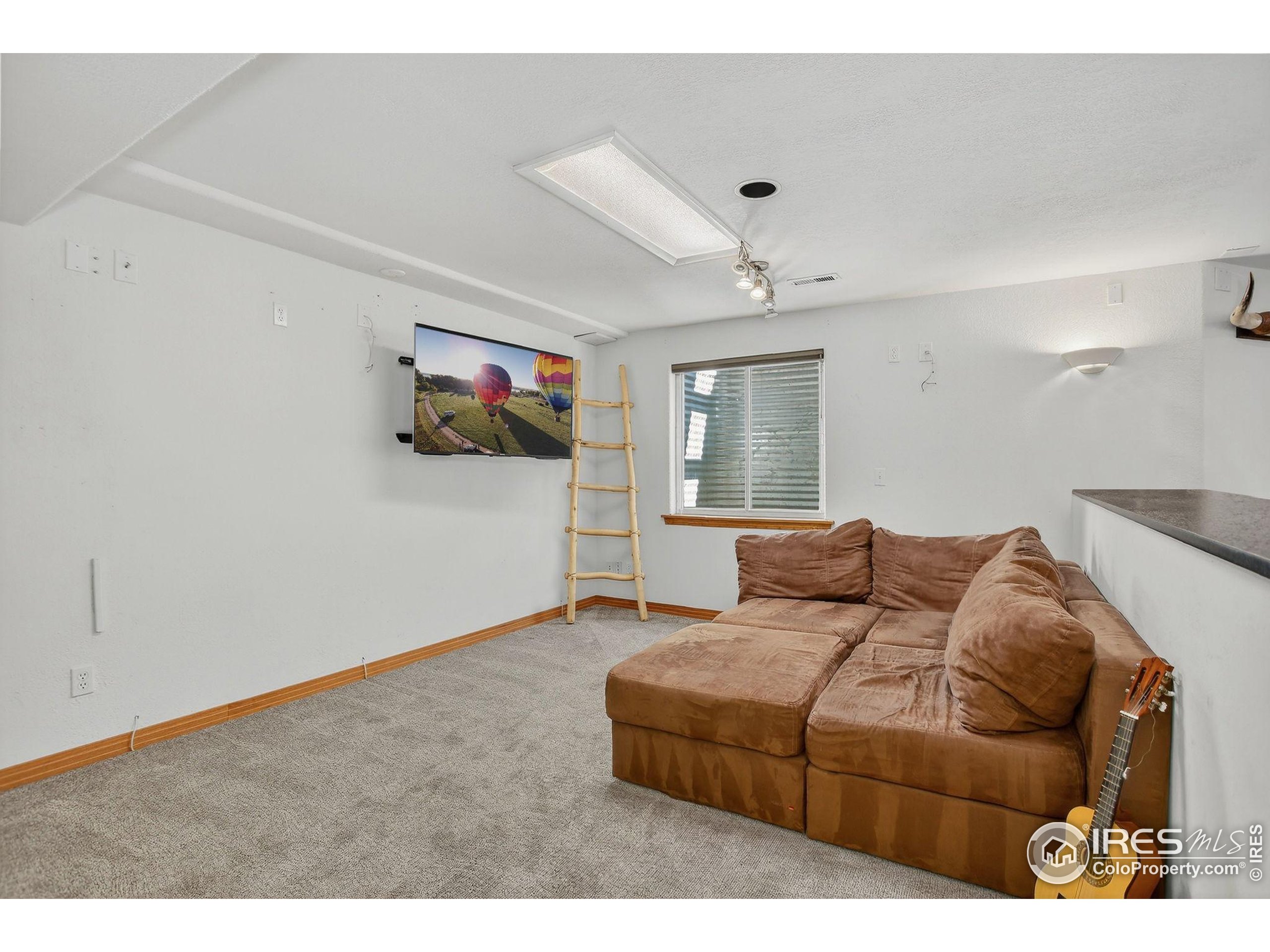 1840 Red Cloud Road Longmont, CO 80504 - Photo 30 of 42 a living room with furniture a ceiling fan and a window