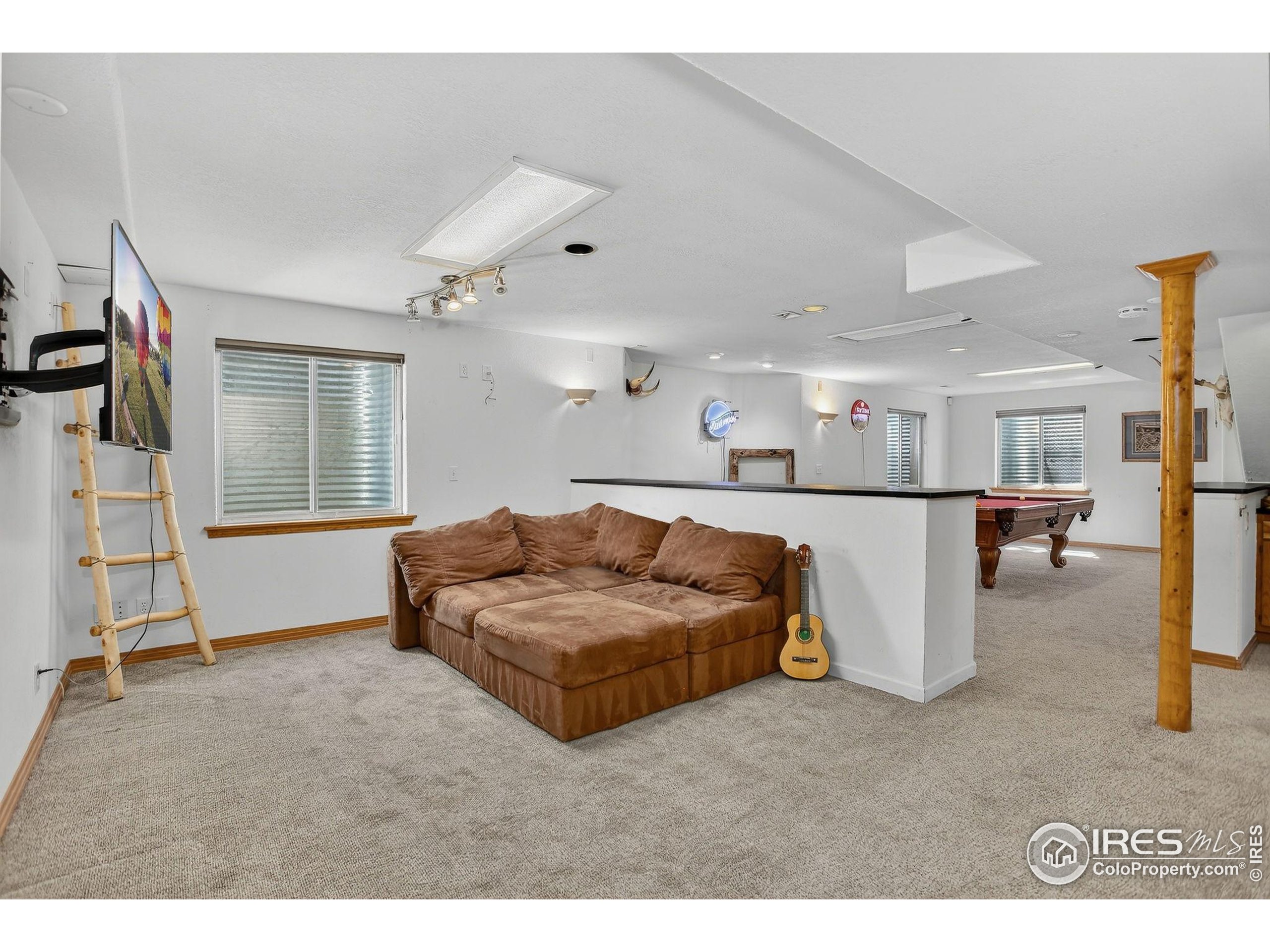 1840 Red Cloud Road Longmont, CO 80504 - Photo 31 of 42 a living room with furniture and a flat screen tv