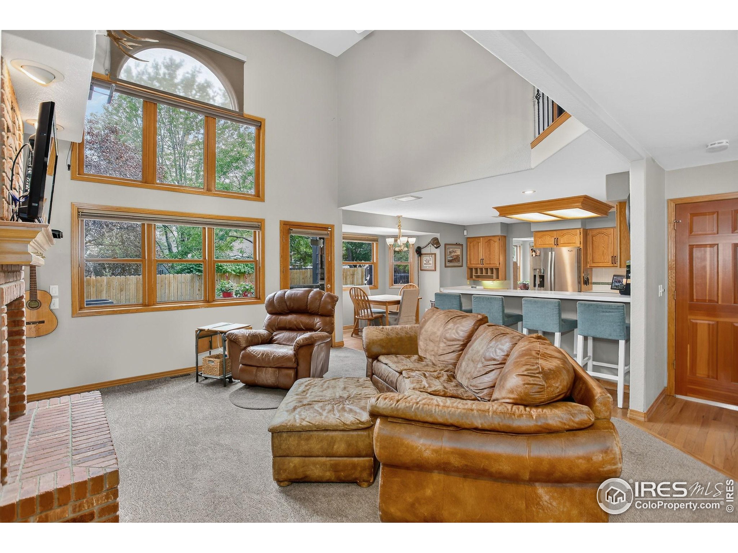 1840 Red Cloud Road Longmont, CO 80504 - Photo 4 of 42 a living room with furniture and a floor to ceiling window