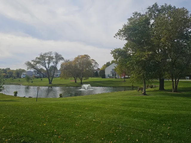 a view of outdoor space with green field and trees