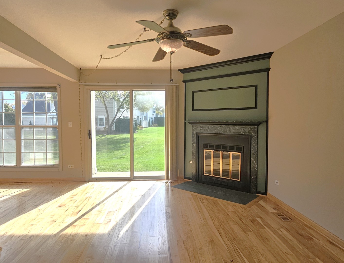475 Bridle Trail Wheeling, IL 60090 - Photo 4 of 27 a view of an empty room with a fireplace and a window