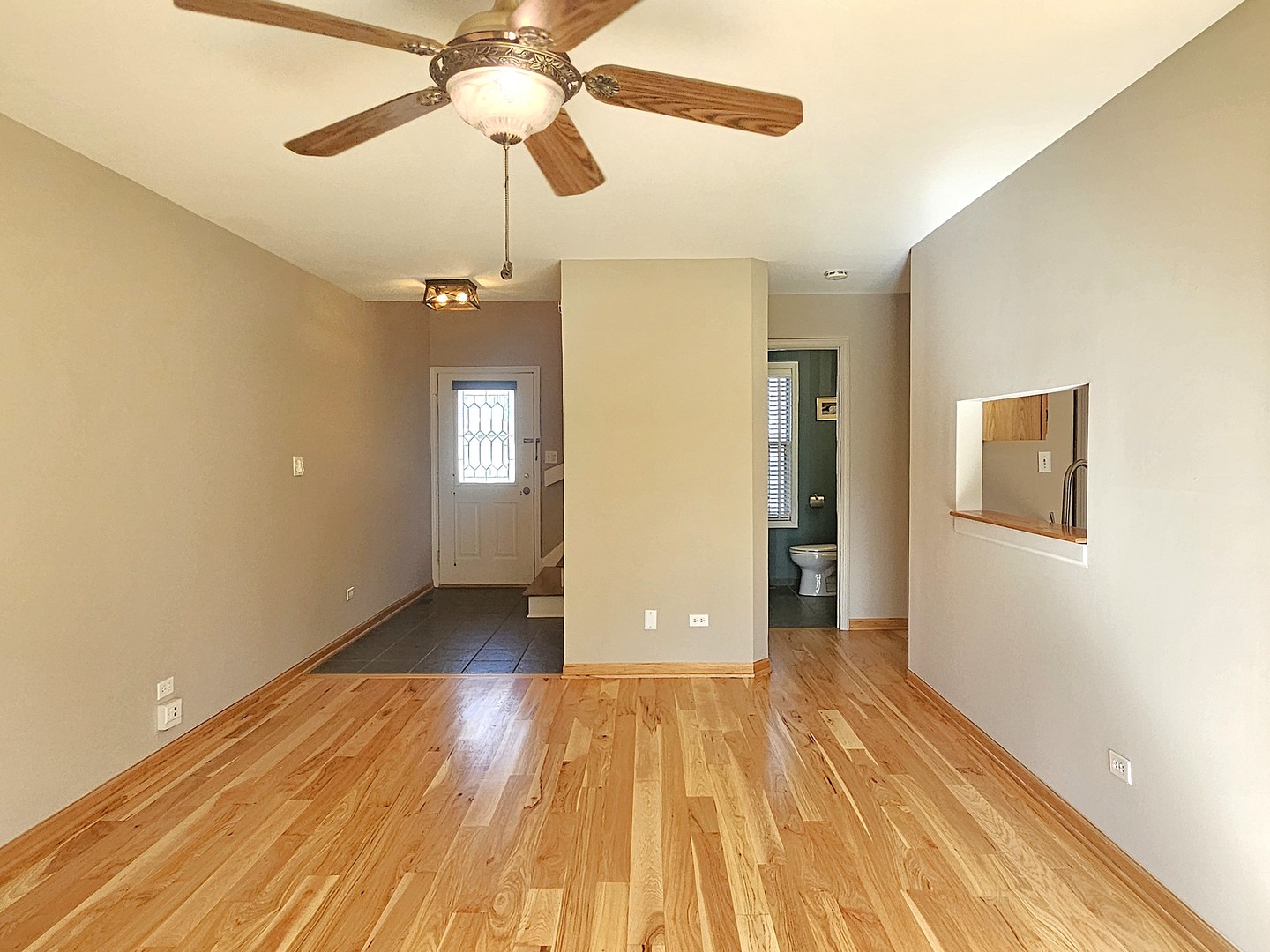 475 Bridle Trail Wheeling, IL 60090 - Photo 5 of 27 a view of an empty room with window and wooden floor
