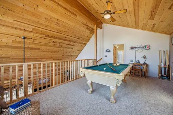 a bedroom with a bed and a flat tv screen