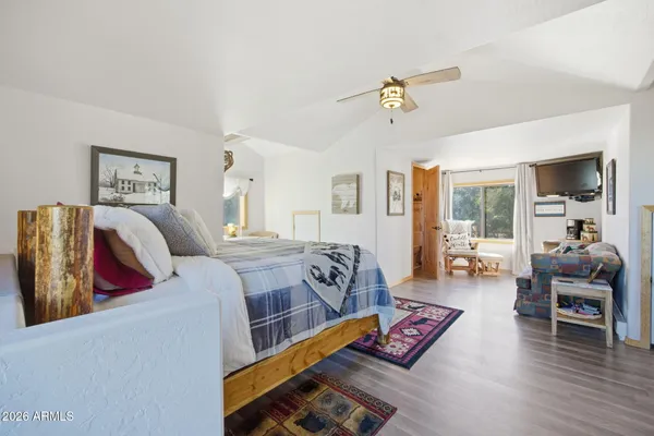 a spacious bedroom with a bed a table and a large window