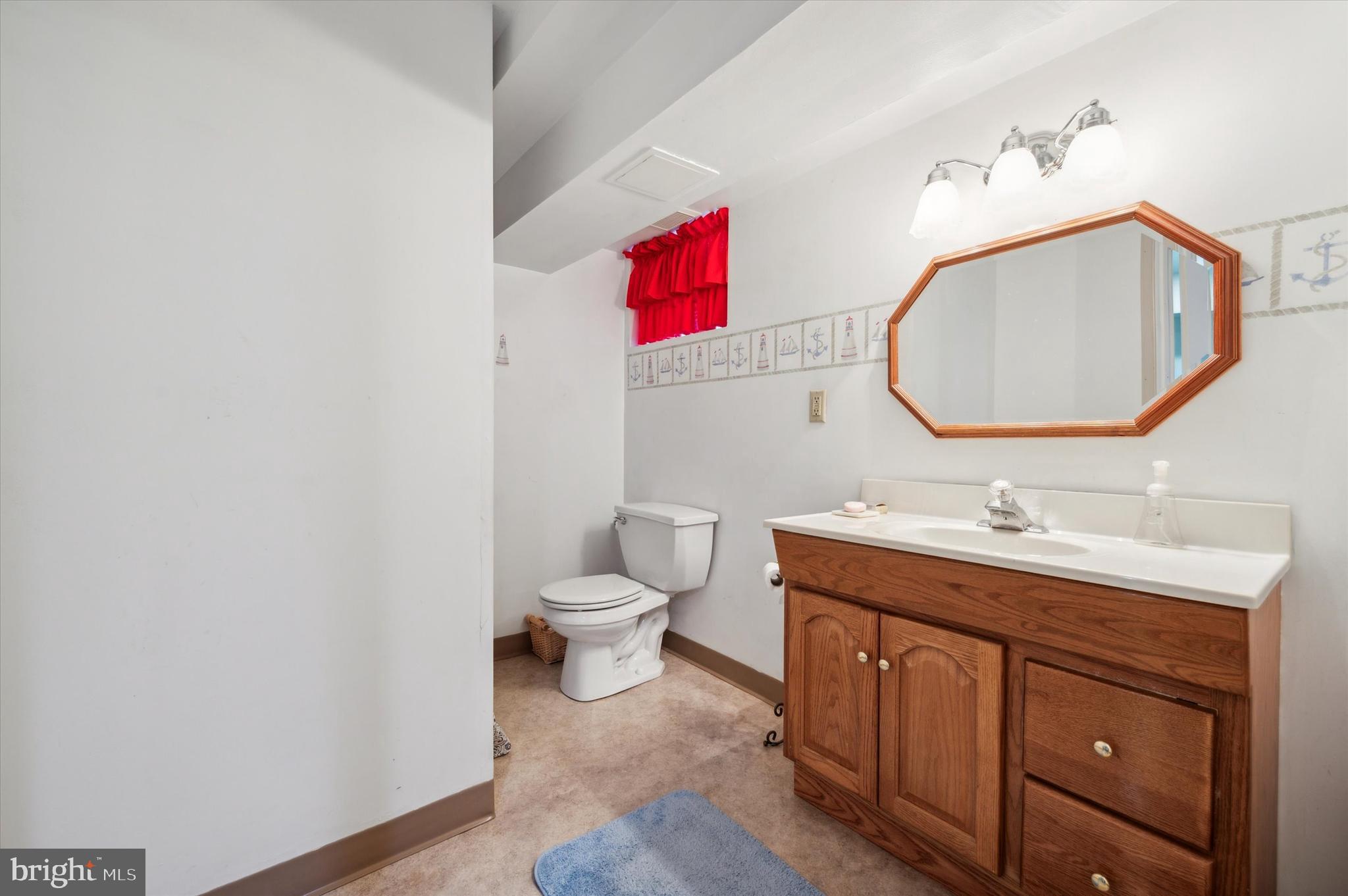 253 Sagamore Road Havertown, PA 19083 - Photo 24 of 25 a bathroom with a toilet sink vanity and mirror