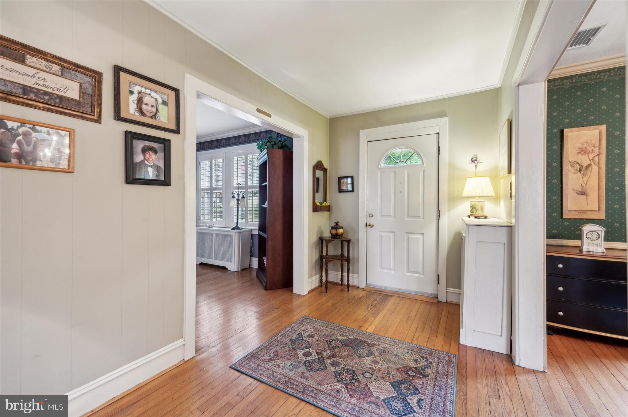 253 Sagamore Road Havertown, PA 19083 - Photo 4 of 25 a view of a hallway with wooden floor and furniture
