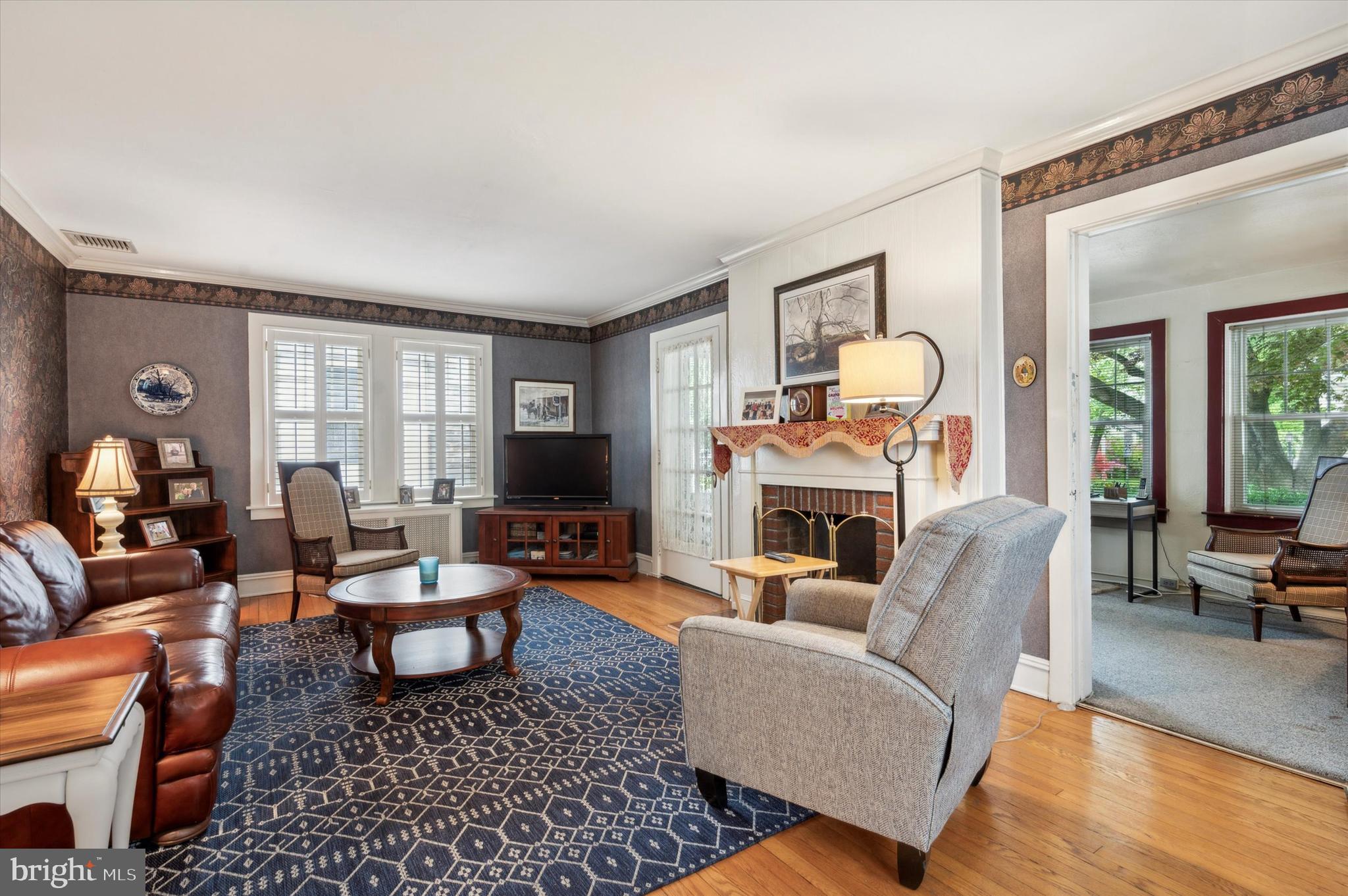 253 Sagamore Road Havertown, PA 19083 - Photo 6 of 25 a living room with furniture a fireplace and a table