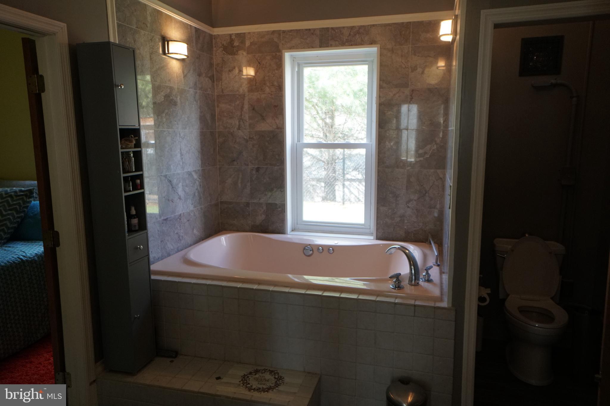 1873 Capito Hill Road Franklin, WV 26807 - Photo 34 of 72 a bath tub sitting next to a window