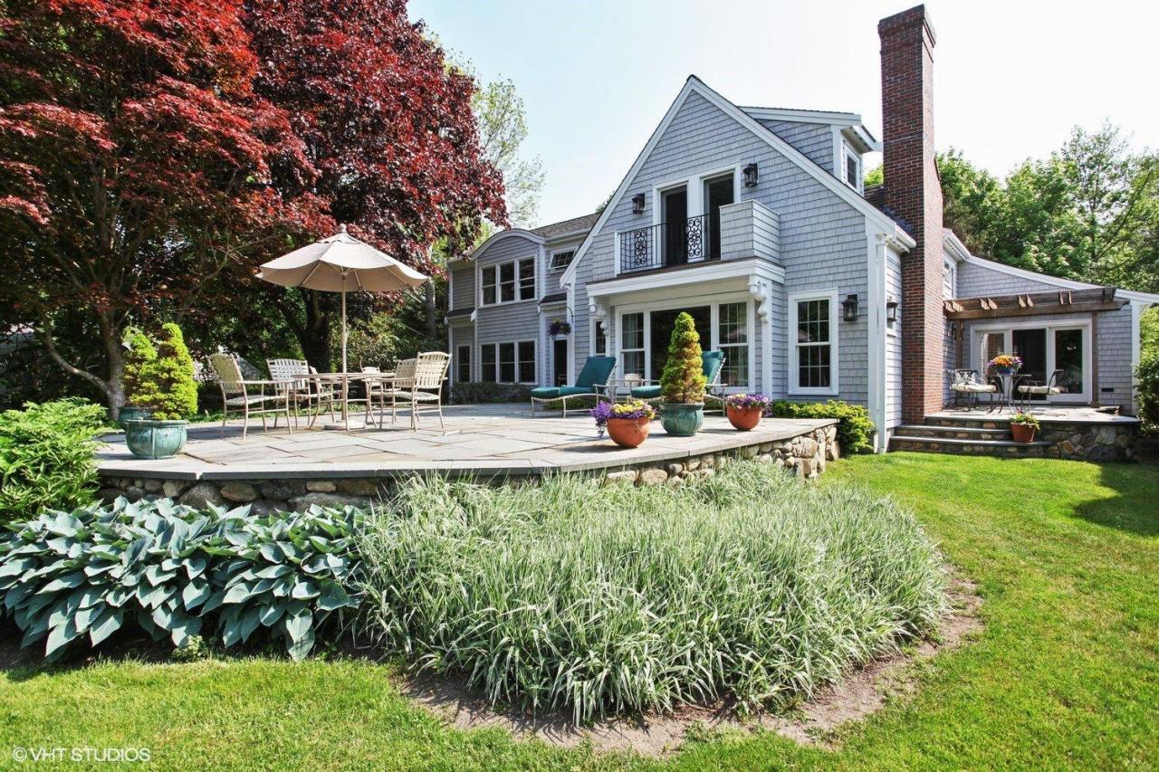 a front view of a house with swimming pool and patio