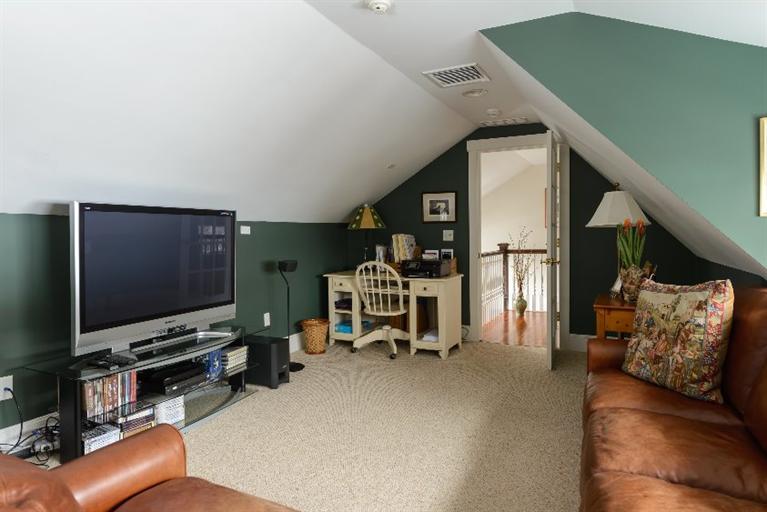 4310 Main Street Barnstable, MA 02675 - Photo 17 of 18 a living room with furniture and a flat screen tv