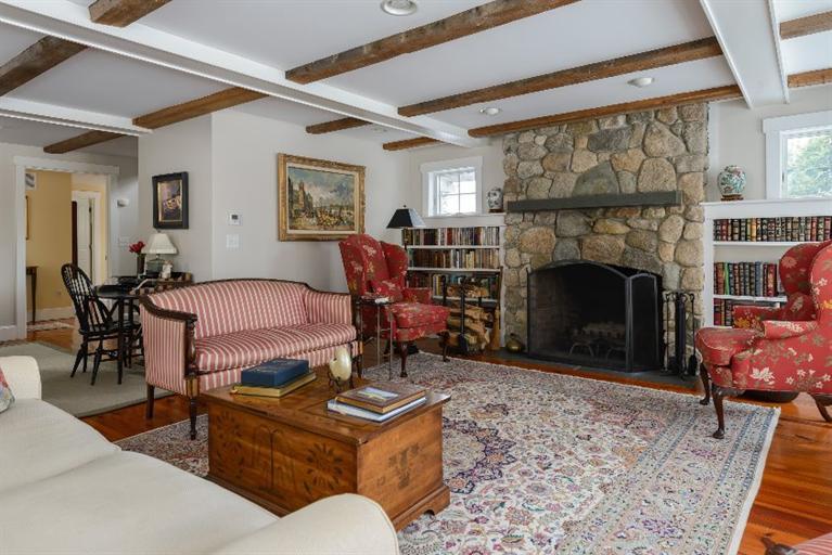 4310 Main Street Barnstable, MA 02675 - Photo 7 of 18 a living room with furniture a flat screen tv and a fireplace
