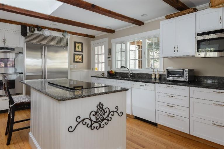 4310 Main Street Barnstable, MA 02675 - Photo 8 of 18 a kitchen with granite countertop a sink stainless steel appliances and white cabinets