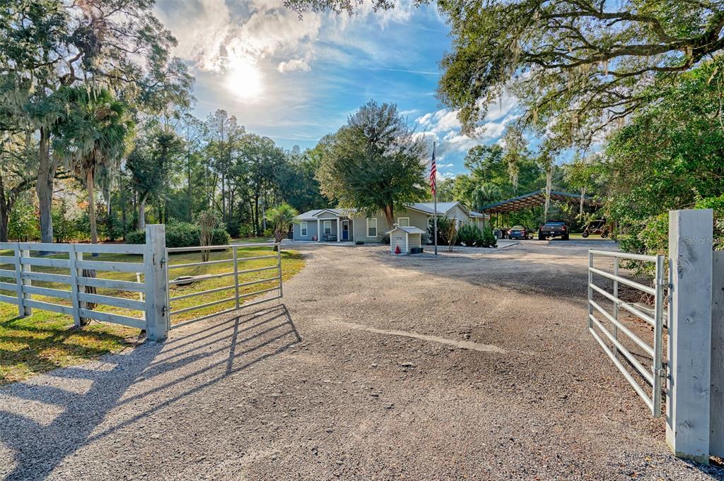a view of a backyard with wooden fence