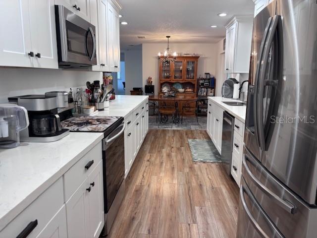1270 Southwest 14th Street Chiefland, FL 32626 - Photo 2 of 41 a kitchen with stainless steel appliances a refrigerator sink and wooden floor