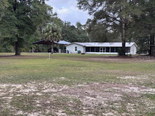 1270 Southwest 14th Street Chiefland, FL 32626 - Photo 30 of 41 a front view of a house with a yard and trees