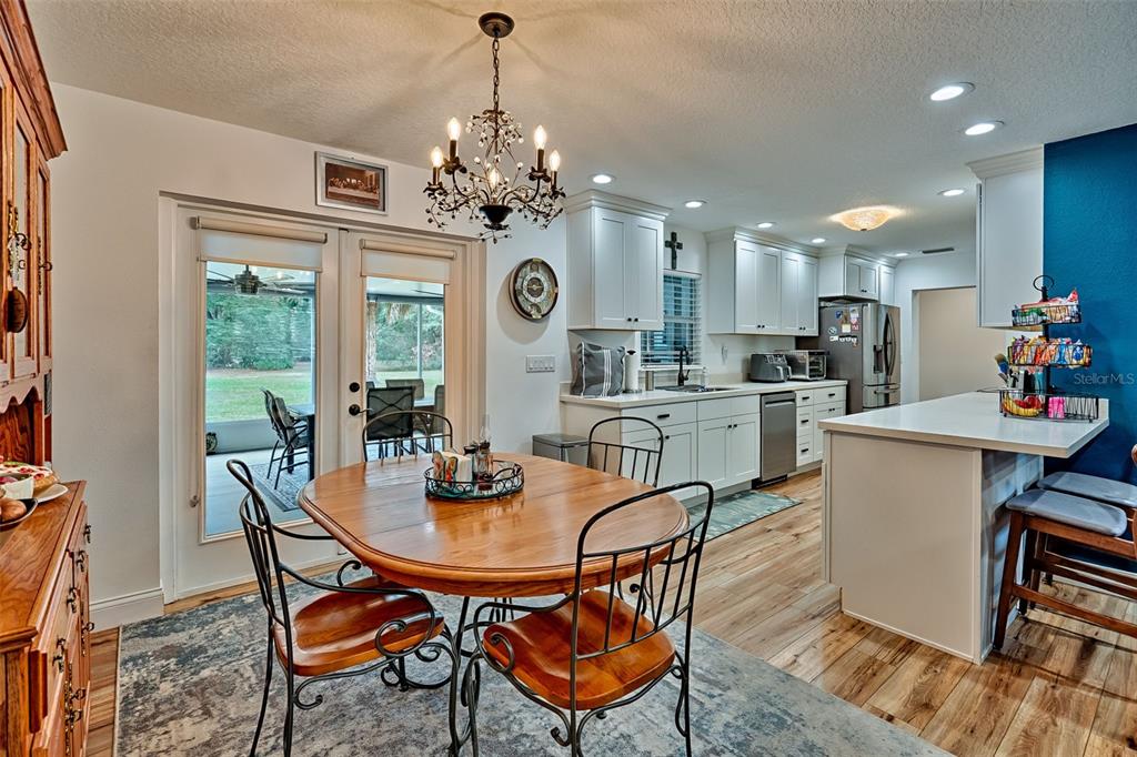 1270 Southwest 14th Street Chiefland, FL 32626 - Photo 4 of 41 a view of a dining room with furniture a chandelier and wooden floor