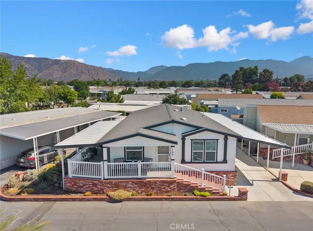 an aerial view of a house with a yard and balcony