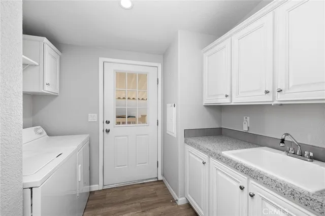 a view of a kitchen with sink dishwasher and wooden floor