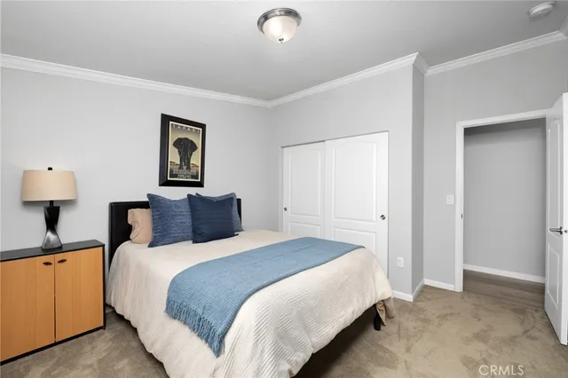 a bedroom with a bed and a lamp