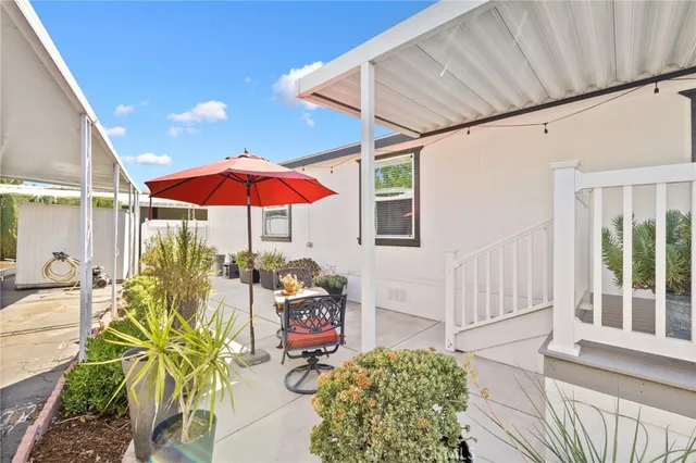 a view of a patio with table and chairs and potted plants