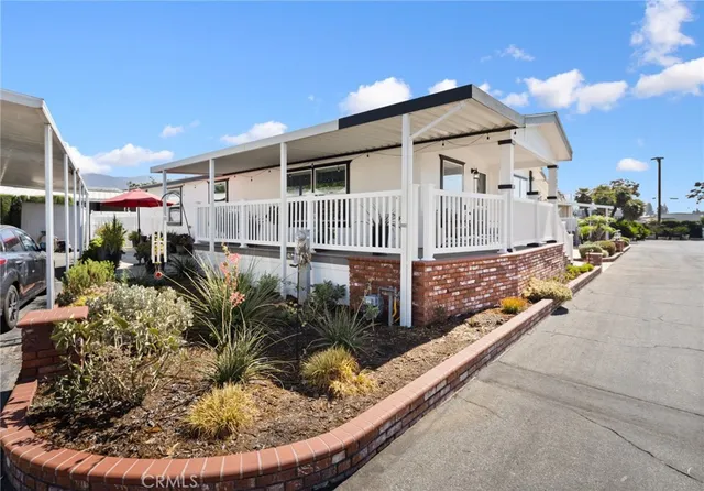a view of a house with backyard and sitting area