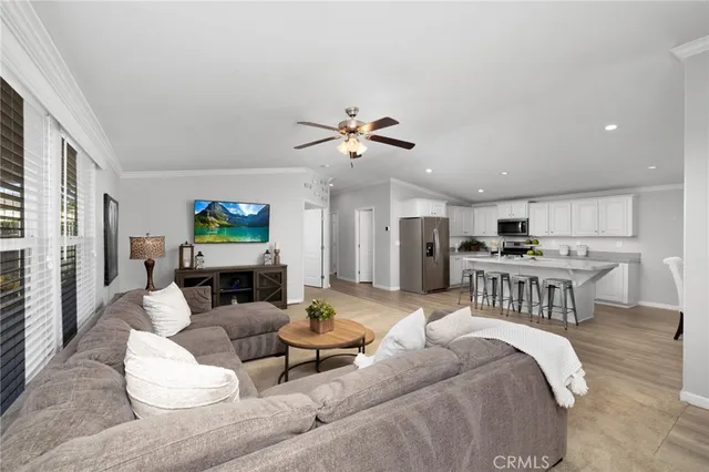 a living room with furniture a fireplace and a kitchen view
