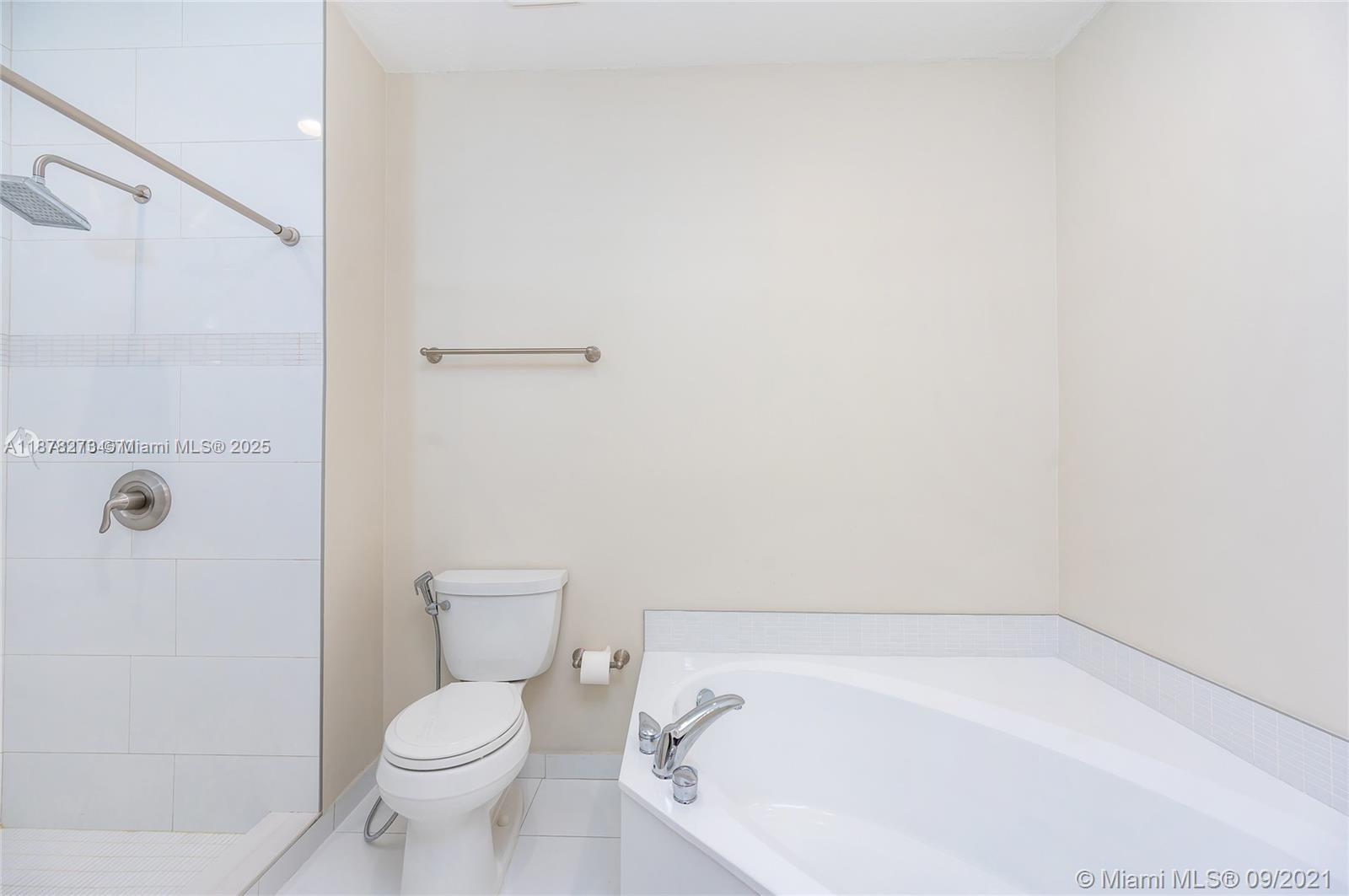 9021 Southwest 94th Street, Unit PH07 Miami, FL 33176 - Photo 14 of 32 a bathroom with a toilet and a shower