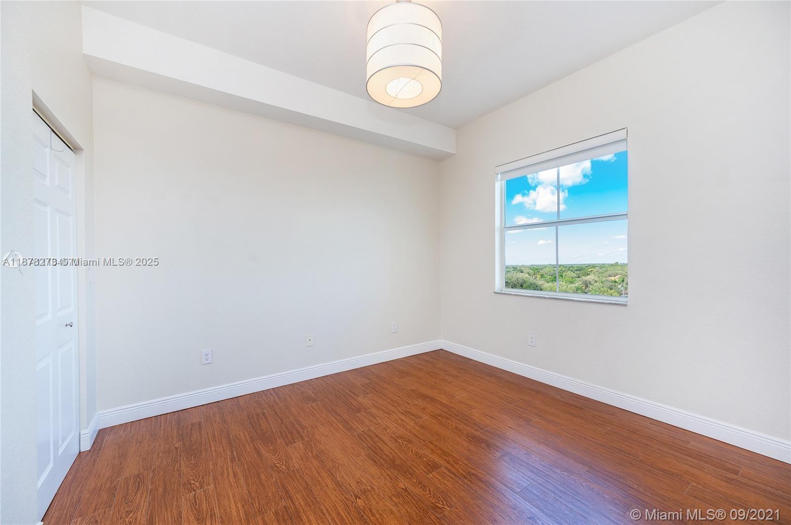 9021 Southwest 94th Street, Unit PH07 Miami, FL 33176 - Photo 18 of 32 a view of empty room with wooden floor