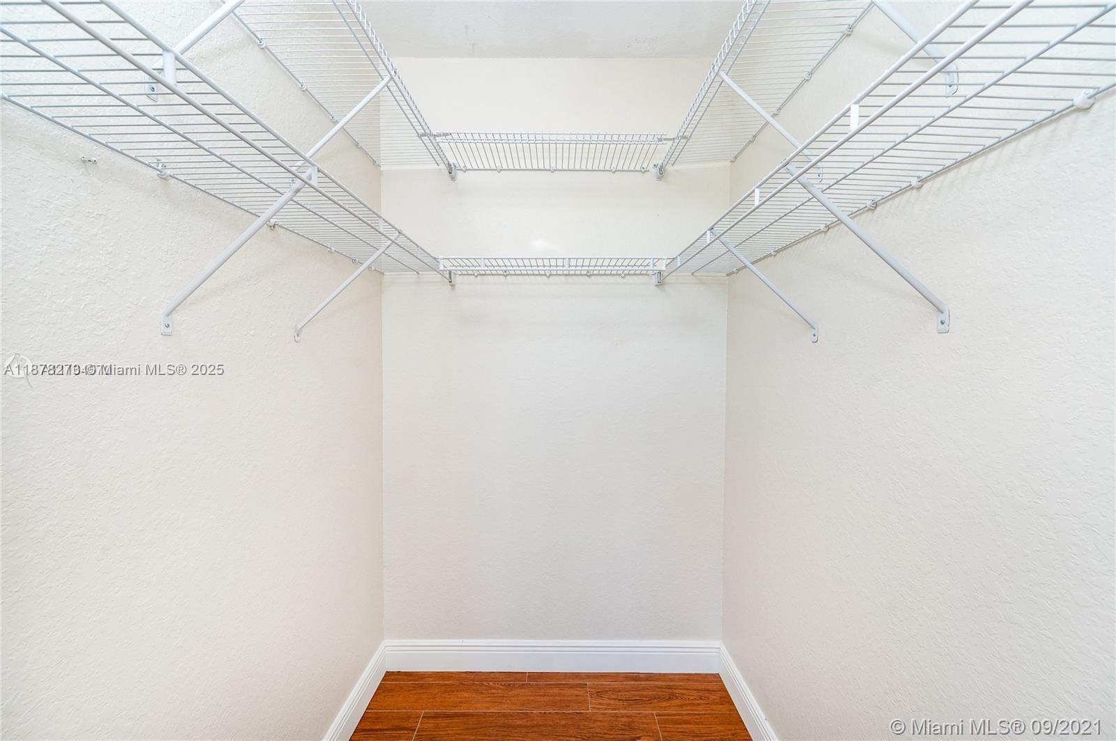 9021 Southwest 94th Street, Unit PH07 Miami, FL 33176 - Photo 20 of 32 a view of a room with racks on the wall