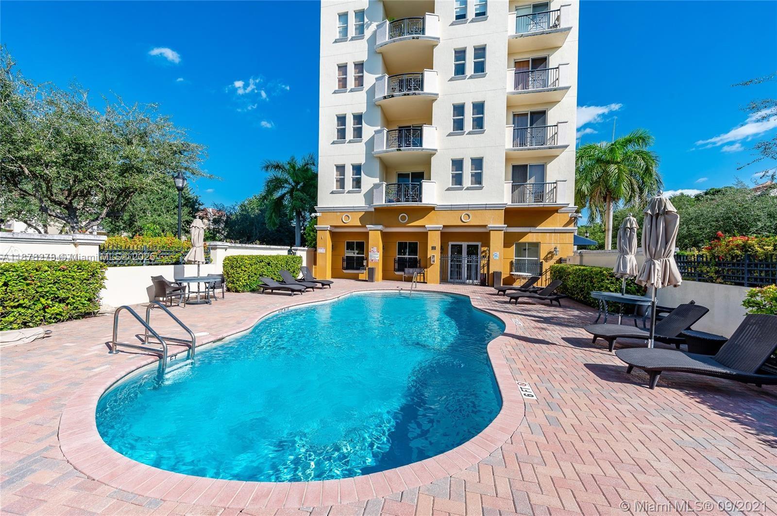 9021 Southwest 94th Street, Unit PH07 Miami, FL 33176 - Photo 29 of 32 a view of a swimming pool with outdoor seating
