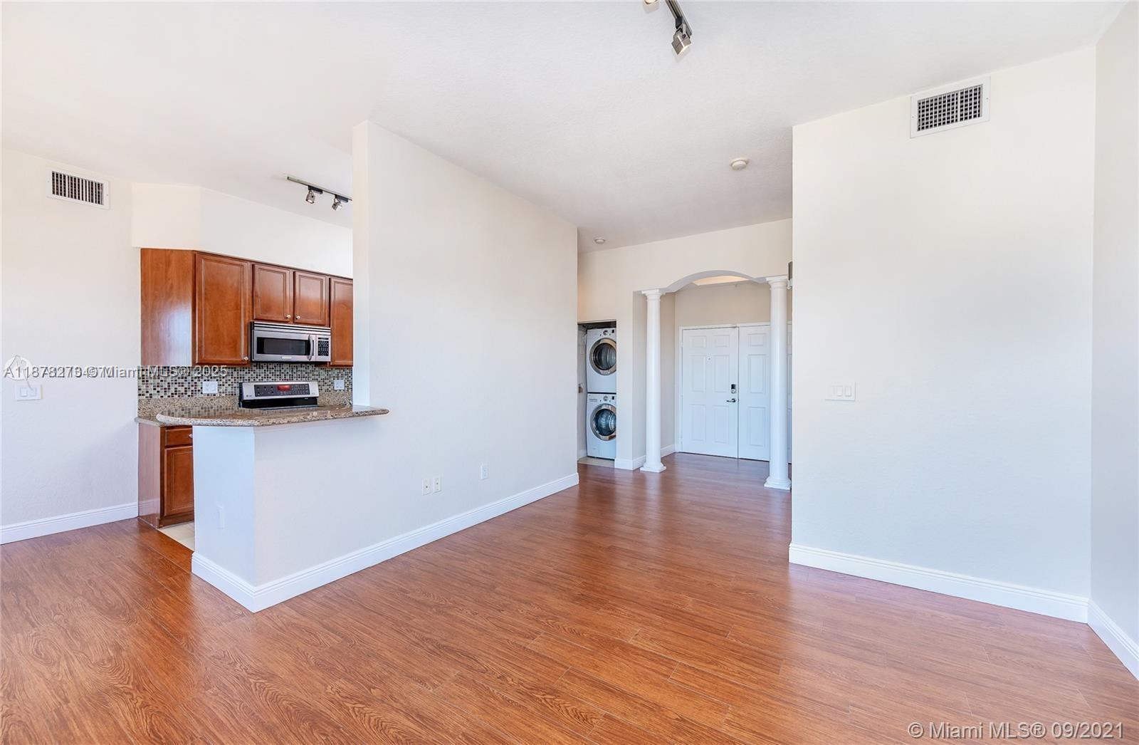 9021 Southwest 94th Street, Unit PH07 Miami, FL 33176 - Photo 6 of 32 a view of a kitchen with wooden floor and electronic appliances