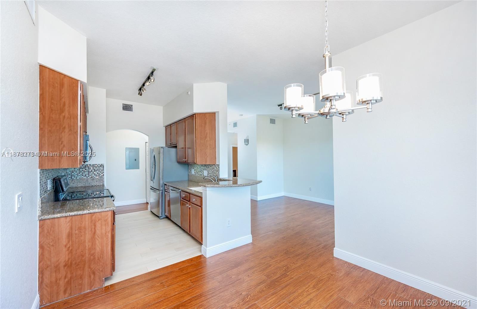 9021 Southwest 94th Street, Unit PH07 Miami, FL 33176 - Photo 9 of 32 a view of kitchen with sink and wooden floor