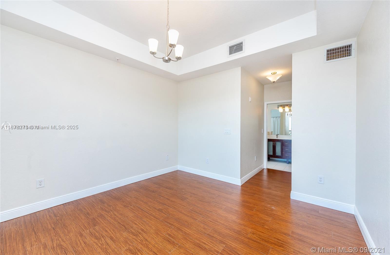 9021 Southwest 94th Street, Unit PH07 Miami, FL 33176 - Photo 10 of 32 a view of empty room with wooden floor
