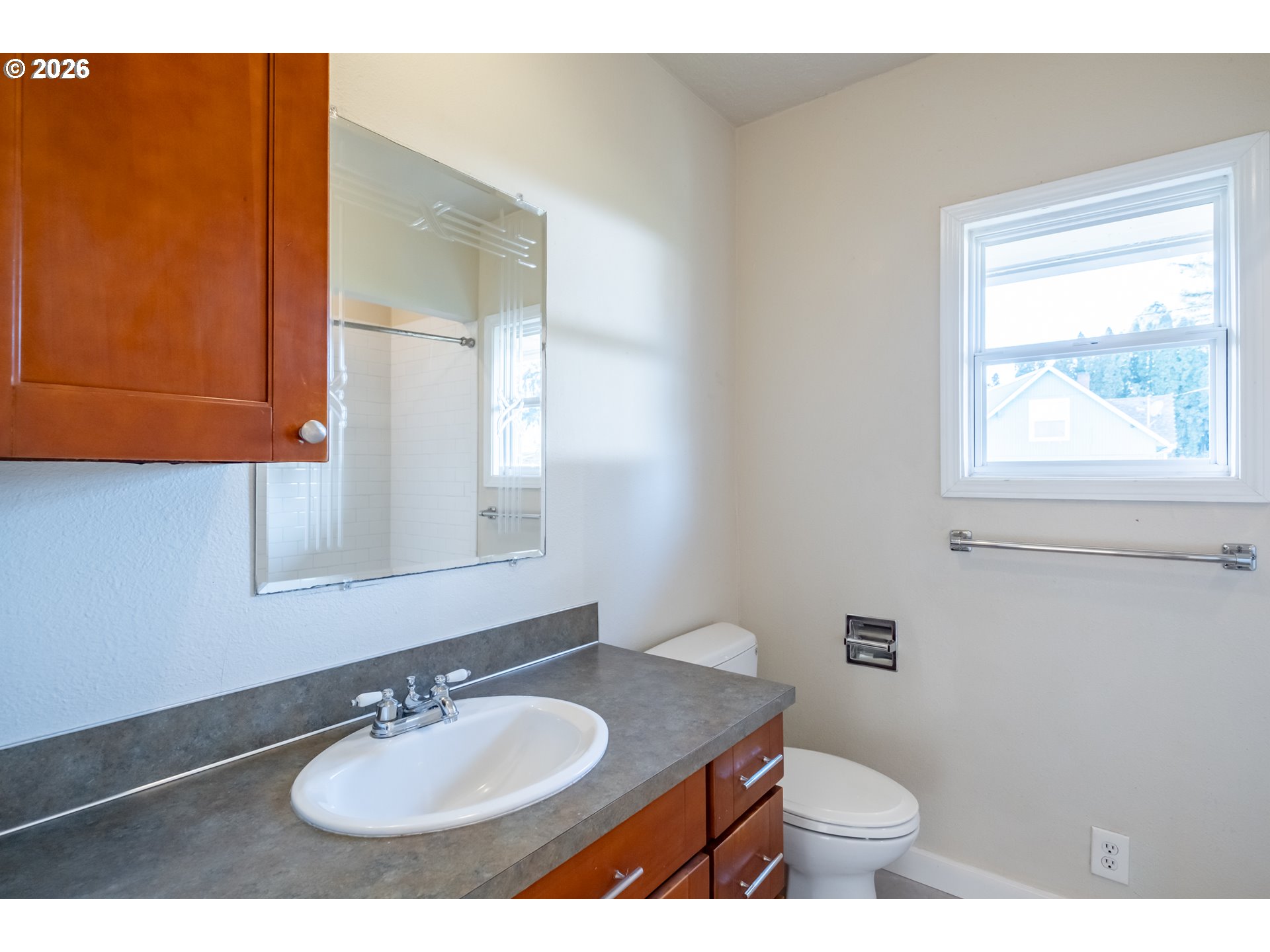 3392 Sunnyview Road Northeast Salem, OR 97301 - Photo 14 of 47 a bathroom with a sink toilet a mirror and vanity