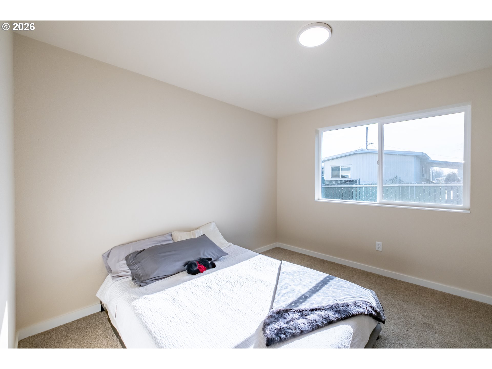 3392 Sunnyview Road Northeast Salem, OR 97301 - Photo 40 of 47 a bedroom with a bed and window