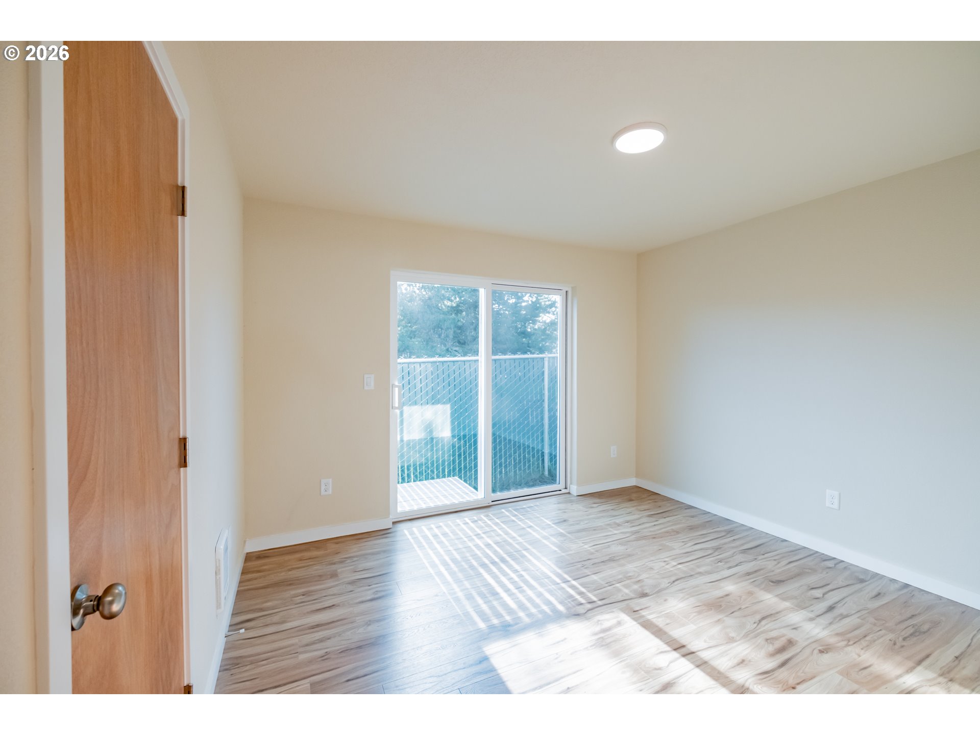 3392 Sunnyview Road Northeast Salem, OR 97301 - Photo 44 of 47 a view of an empty room with wooden floor and a window