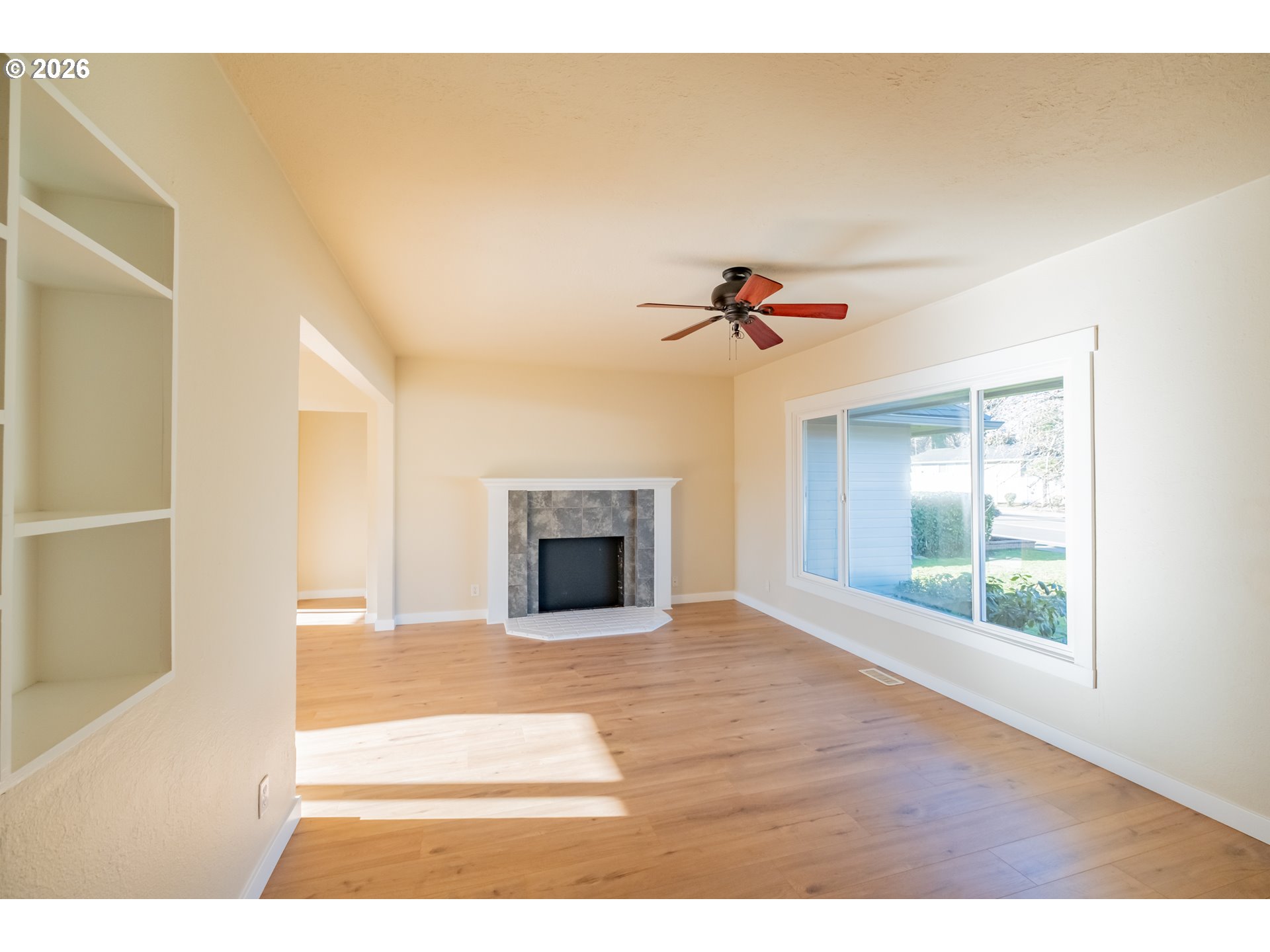 3392 Sunnyview Road Northeast Salem, OR 97301 - Photo 5 of 47 a view of an empty room with wooden floor and a window