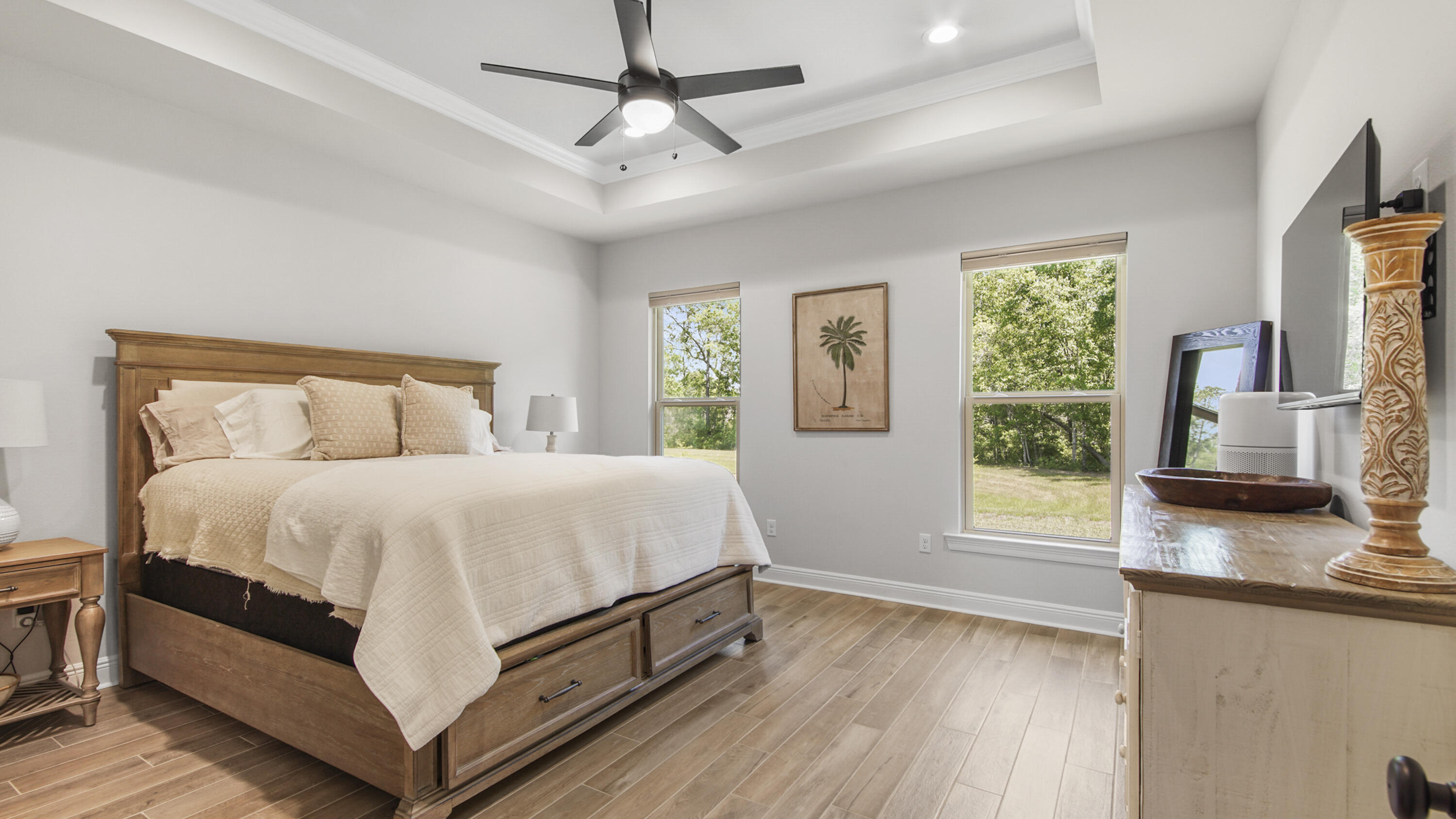 115 Flora Lane Freeport, FL 32439 - Photo 12 of 69 a bedroom with a large bed and a flat tv screen on dresser