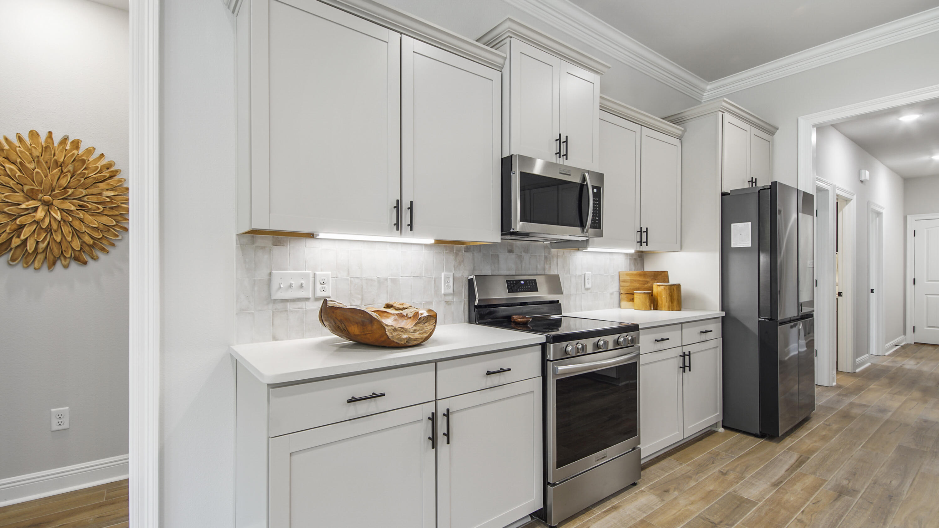 115 Flora Lane Freeport, FL 32439 - Photo 24 of 69 a kitchen with stainless steel appliances a stove microwave and refrigerator