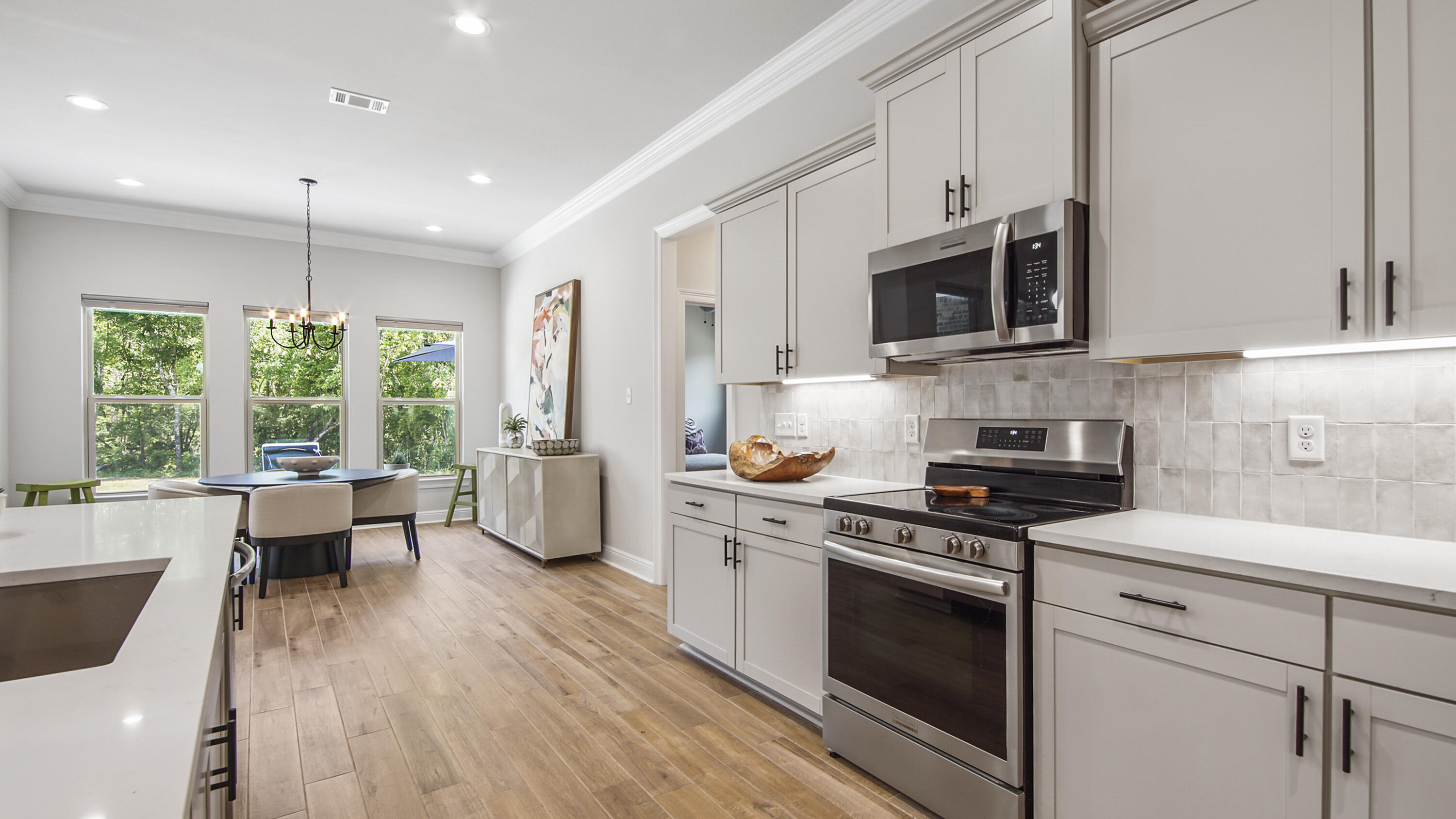 115 Flora Lane Freeport, FL 32439 - Photo 26 of 69 a kitchen with stainless steel appliances white cabinets a sink a stove a refrigerator and cabinets
