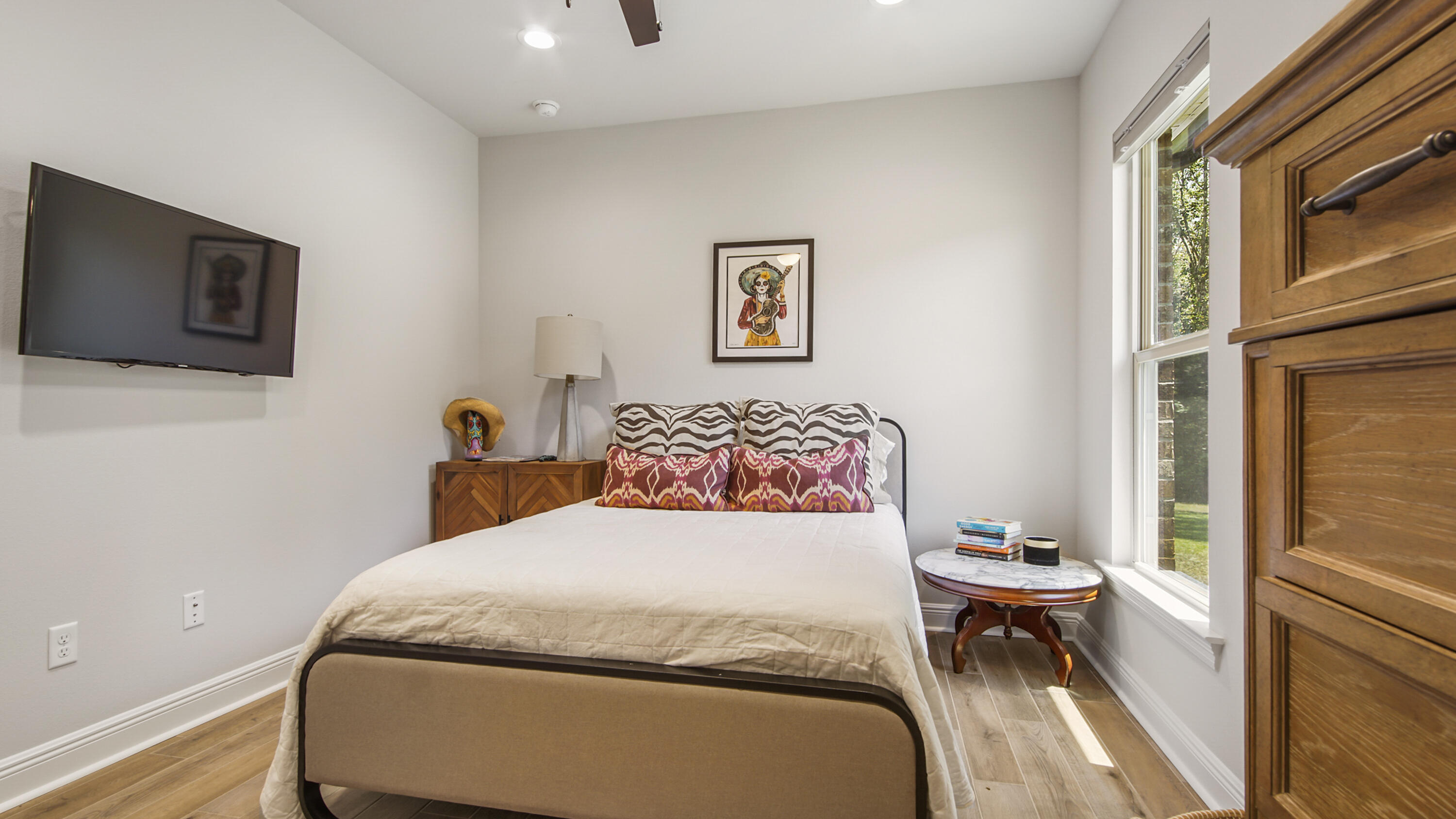 115 Flora Lane Freeport, FL 32439 - Photo 30 of 69 a bedroom with a bed and a flat screen tv