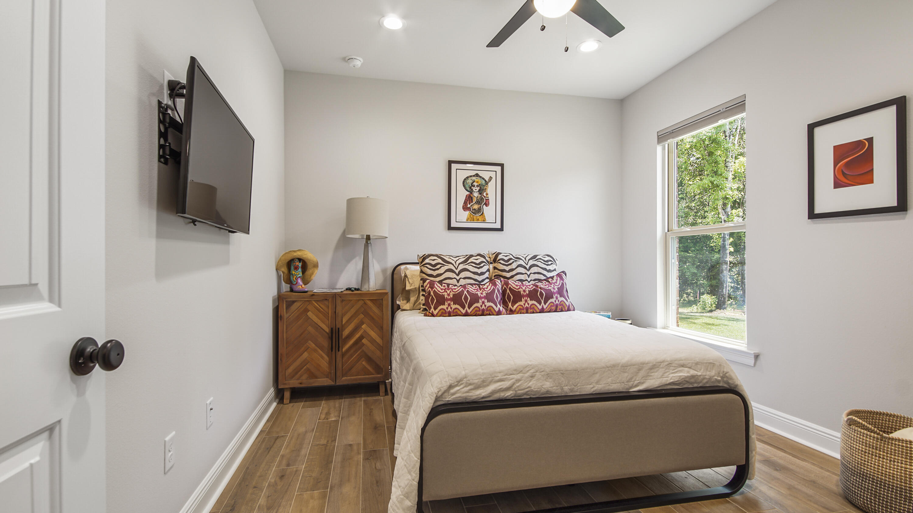 115 Flora Lane Freeport, FL 32439 - Photo 31 of 69 a bedroom with a bed a flat screen tv and a window