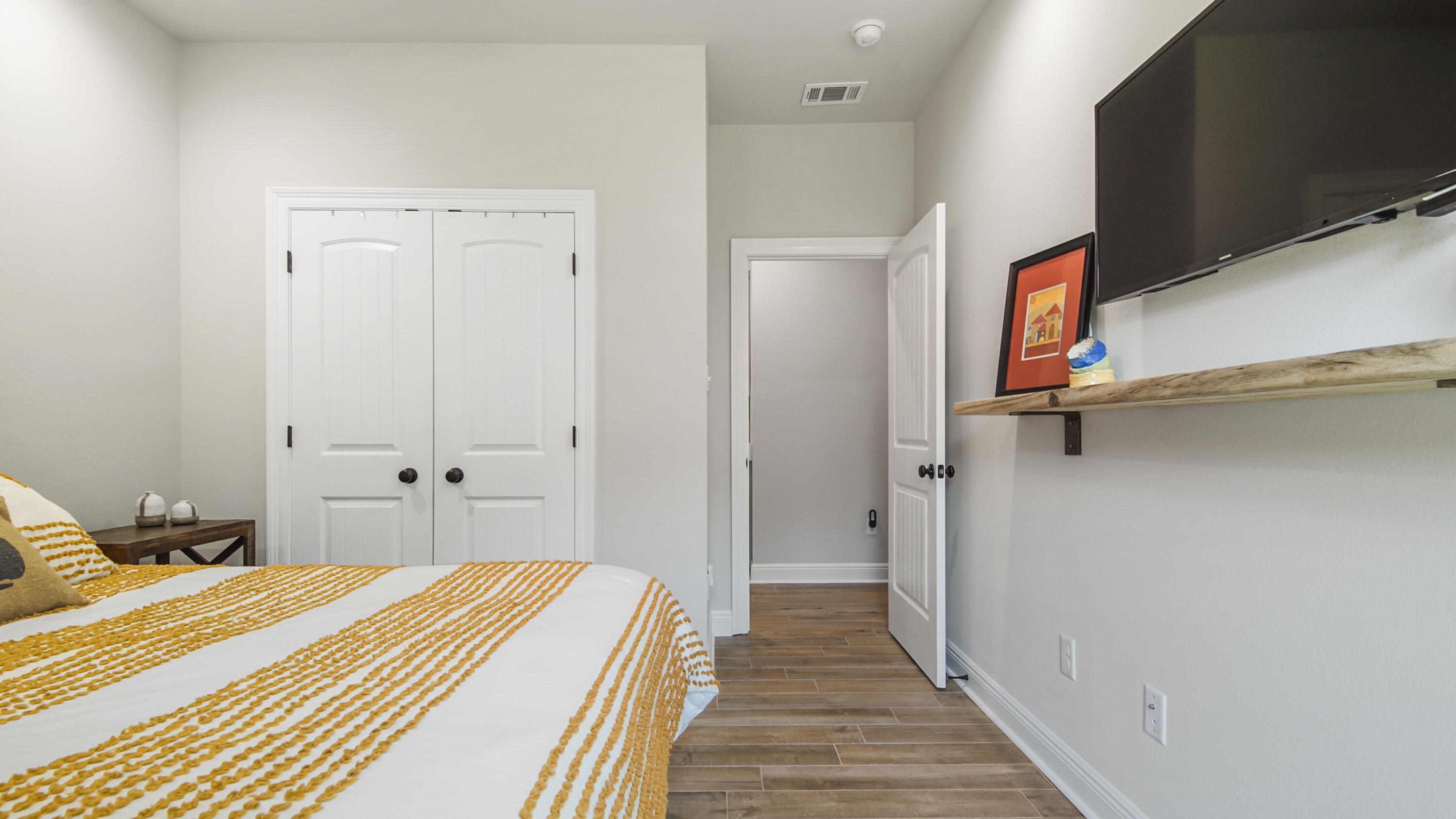 115 Flora Lane Freeport, FL 32439 - Photo 45 of 69 a bedroom with a bed and wooden floor