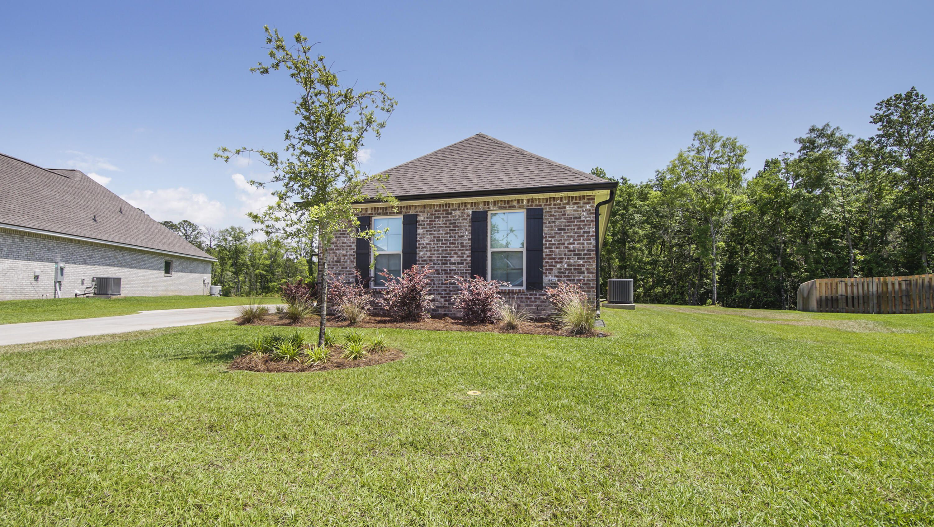 115 Flora Lane Freeport, FL 32439 - Photo 67 of 69 a view of a house with a yard and a garden