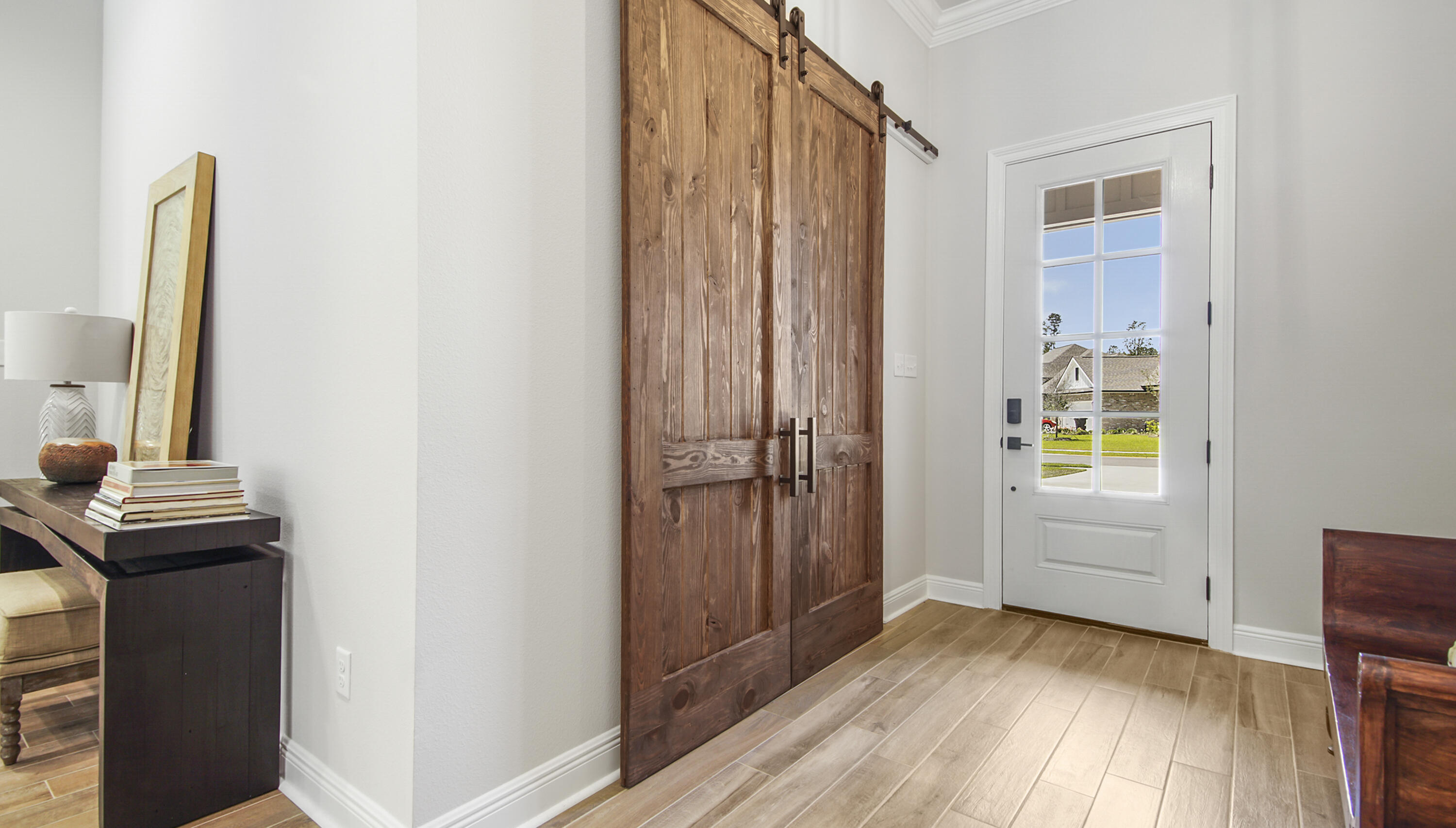 115 Flora Lane Freeport, FL 32439 - Photo 10 of 69 a view of a hallway with wooden floor and a bathroom