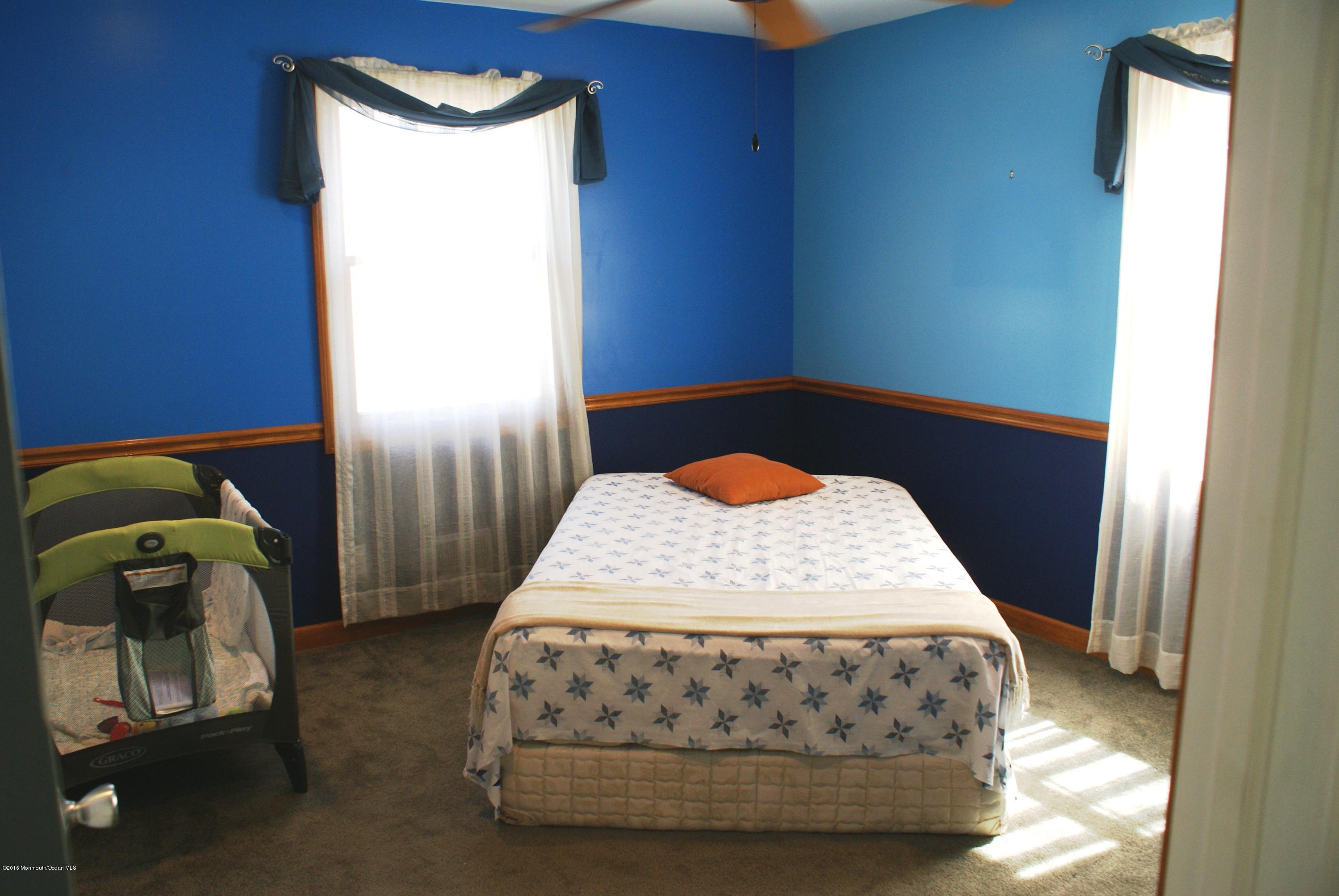 53 Tennent Road Morganville, NJ 07751 - Photo 6 of 11 a bedroom with a bed and a mirror