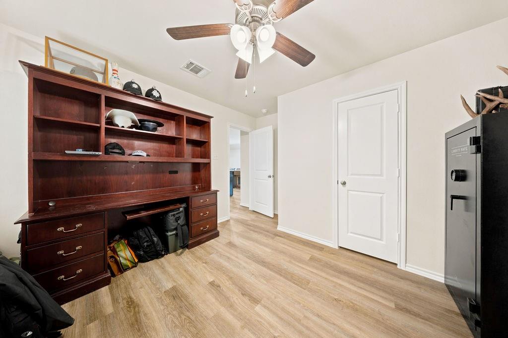 822 Ramble Road Lavon, TX 75166 - Photo 20 of 35 Interior room featuring wood-finish flooring, light-toned walls, and a ceiling fan with integrated lighting